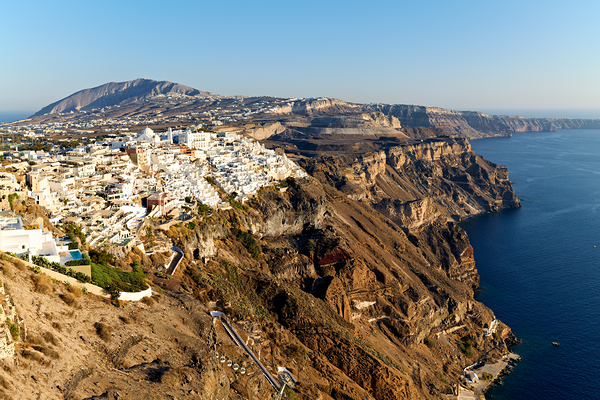 Santorinis white buildings on caldera cliffs above the sea. Digital Download
