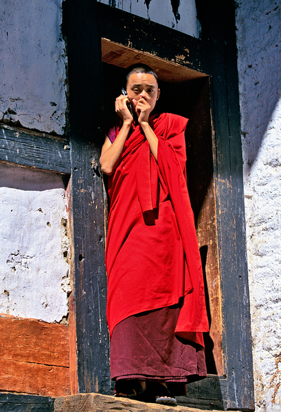 Monk in red robes on cell phone. Digital Download