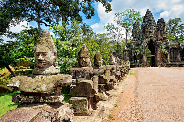 Ancient stone statues line path to Angkor Thom gate. Digital Download