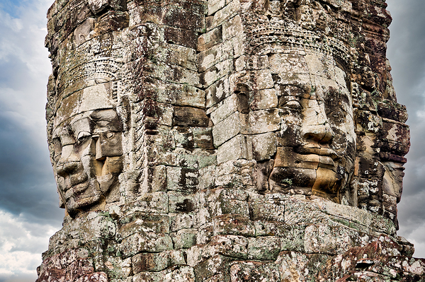 Ancient stone faces carved into Bayon Temple Cambodia. Digital Download