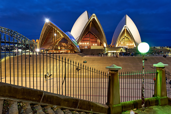 Sydney Opera House illuminated at dusk with crowds on steps. Digital Download