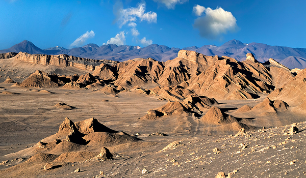 Rugged desert mountains under a clear blue sky with clouds. Digital Download