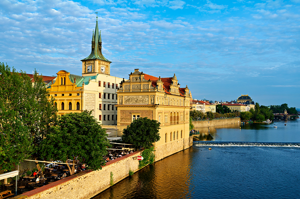Pragues Vltava riverfront with historic architecture and lively Digital Download