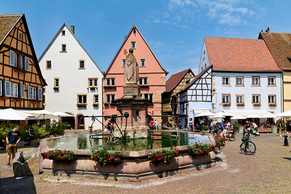 Visitors enjoy Saint Leon square in Eguisheim Alsace on a sunny Digital Download