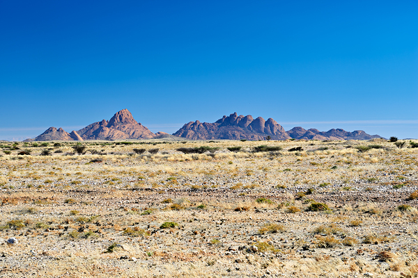 Granite peaks of Spizkoppe rise in Namib Desert landscape Digital Download