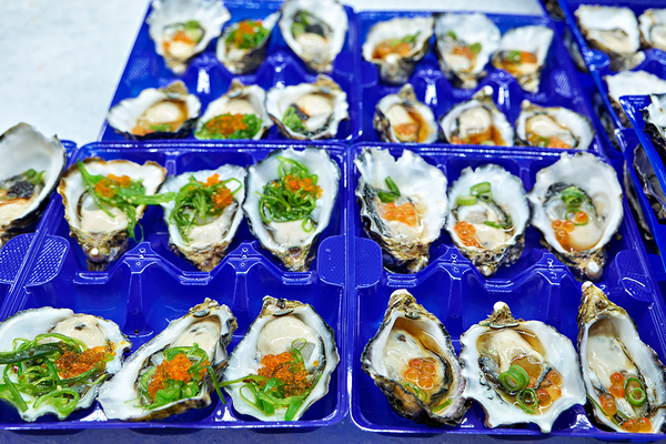 Fresh oysters with garnishes in blue trays. Digital Download