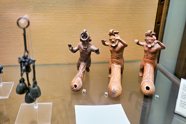 Displays of ancient artifacts are shown in glass cases Digital Download