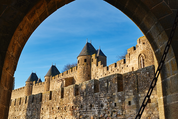 Exploring the historic walls of Carcassonne in France under blue Digital Download
