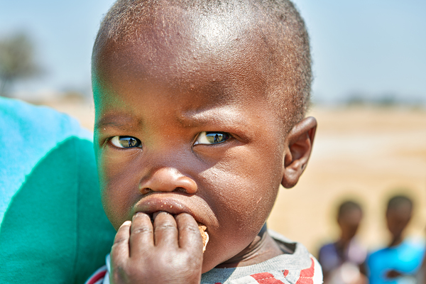Sad boy in Kavango Region of Namibia looks thoughtful and lost Digital Download