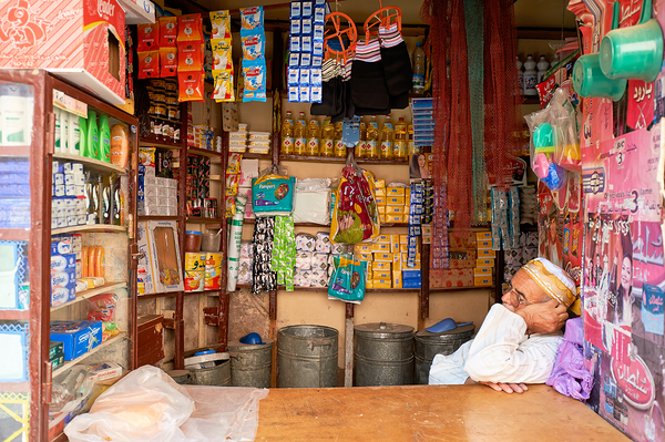 Grocer sleeping in shop in Marrakesh during afternoon hours Digital Download