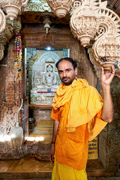Hindu monk stands near statue in Jaisalmer Jain temple Digital Download