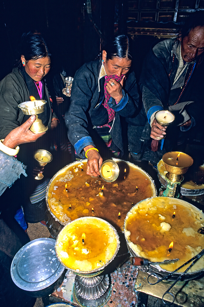 Lighting butter lamps during a ceremony in Tibet Digital Download