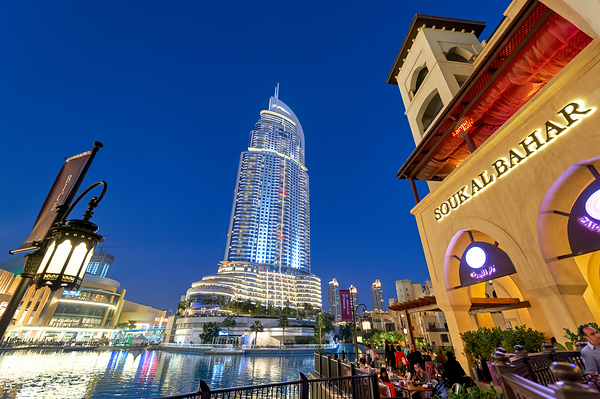 Night lights and waterfront dining in Dubai cityscape Digital Download