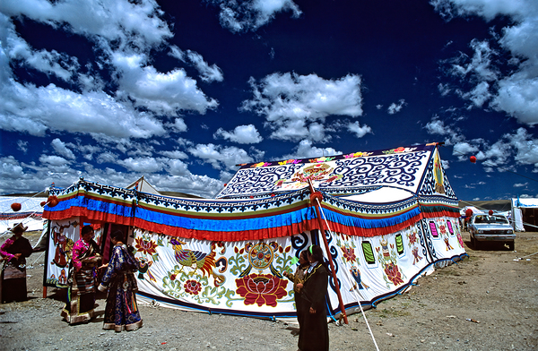 Colorful Tibetan tent with people under a cloudy sky in Tibet Digital Download