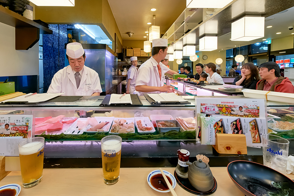 Sushi bar in Shibuya district with chefs and guests enjoying mea Digital Download