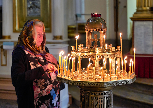 Woman lights candles at Alexander Nevsky Lavra Digital Download