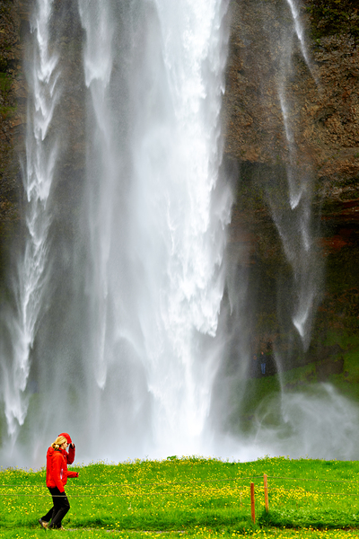 Woman walks near Seljalandsfoss waterfall in Iceland Digital Download