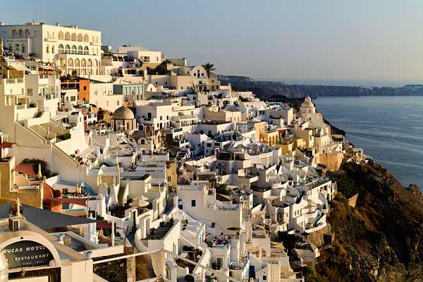 Santorinis white buildings cascade down cliff to the sea. Digital Download