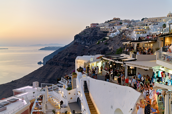 Santorini cliffside town with restaurants and people enjoying th Digital Download