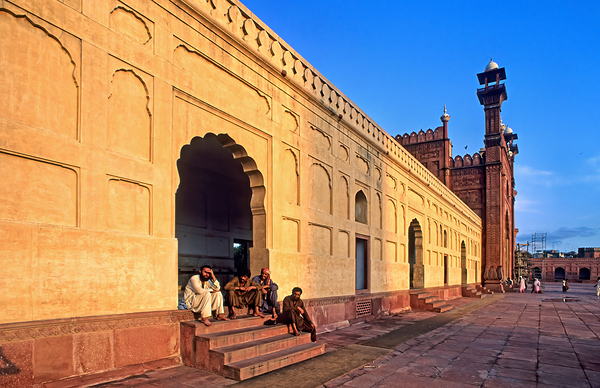 Visitors rest by Badshahi Mosque during sunset in Lahore Digital Download