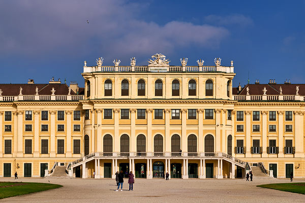 Ornate yellow palace facade with people and blue sky. Digital Download