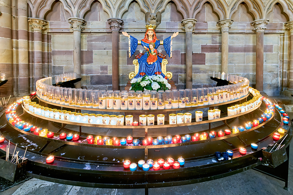 Visitors light votive candles near statue in Strasbourg Cathedra Digital Download