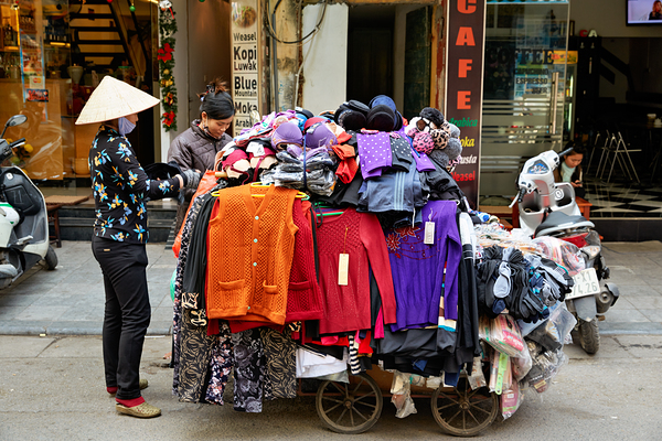 Market scene in Hanoi with a man selling clothes on a cart Digital Download