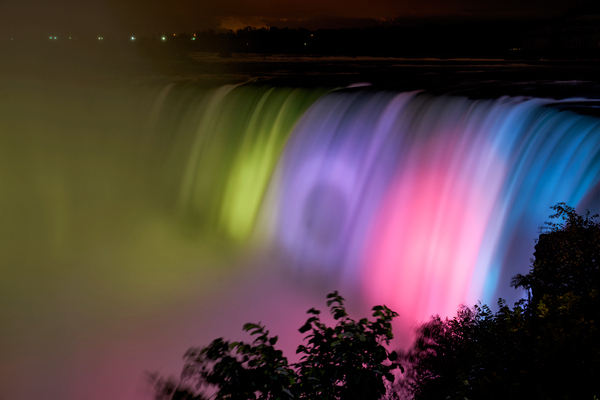 Niagara Falls illuminated with vibrant colors at night. Digital Download