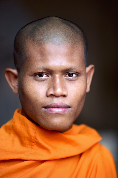 Young Buddhist monk in orange robe close up portrait. Digital Download