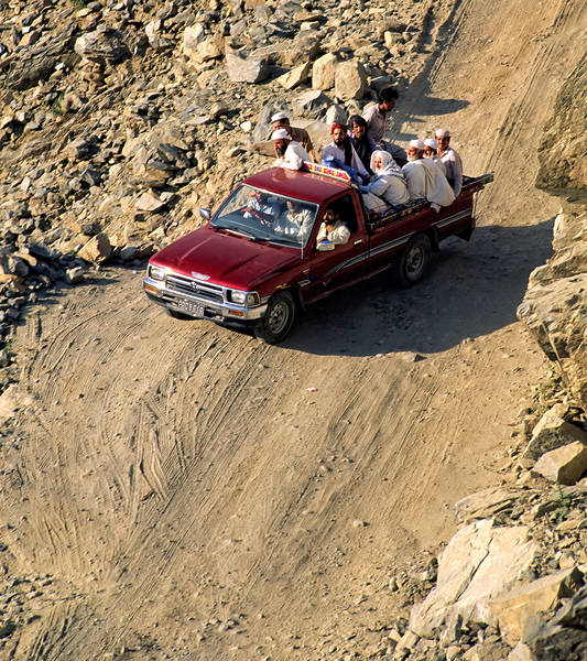 Travelers on gravel road near Shandur Pass in Pakistan Digital Download