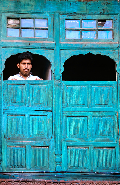 Man looks out from window in Lahore Pakistan Digital Download