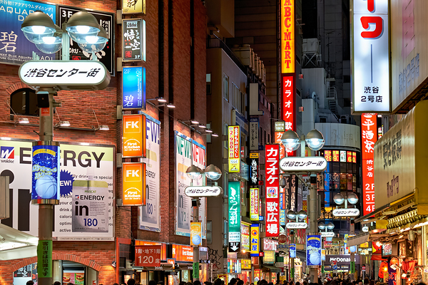 Neon lights shine bright in Shibuya district at night in Tokyo Digital Download