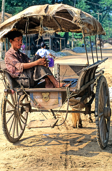 Man rests on cart in Myanmar during warm daytime Digital Download