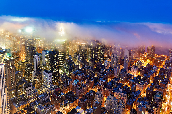 Aerial view shows Manhattan skyline at dusk with city lights Digital Download