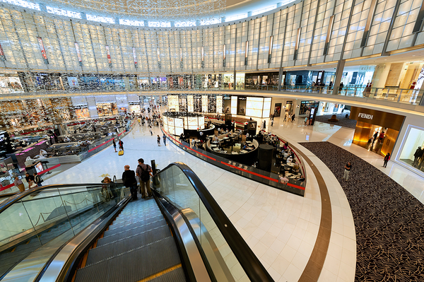 Busy shopping mall in Dubai with escalators and various stores Digital Download
