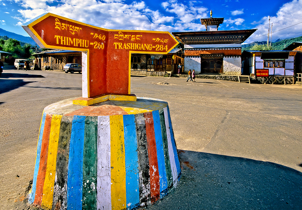 Colorful Bhutanese signpost directs to Thimphu and Trashigang. Digital Download