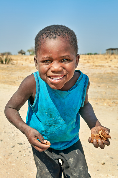 Joyful boy in Kavango Region of Namibia enjoys a moment outside Digital Download