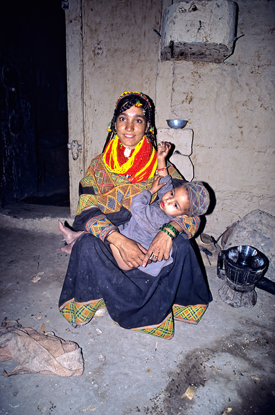 A woman holds her child in a Kalash village Digital Download