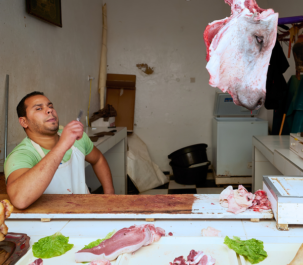 Butcher at work in Meknes souk showing fresh meat and livestock Digital Download
