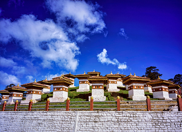 Traditional Bhutanese chortens on a green hill blue sky. Digital Download
