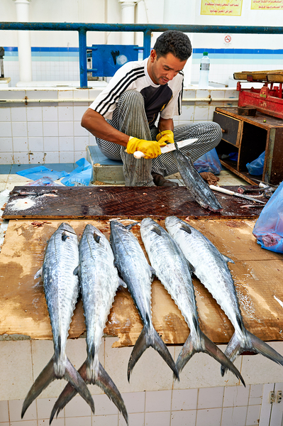 Fish seller prepares catch at Nizwa Oman fish market Digital Download