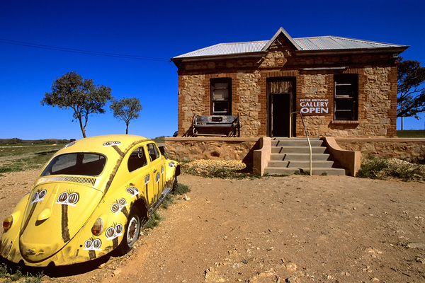 A painted yellow Beetle outside a rural stone gallery. Digital Download
