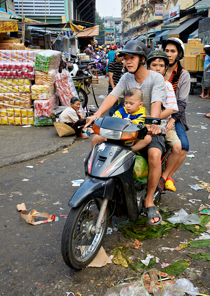 Motorbike family ride through busy Ho Chi Minh street in Vietnam Digital Download