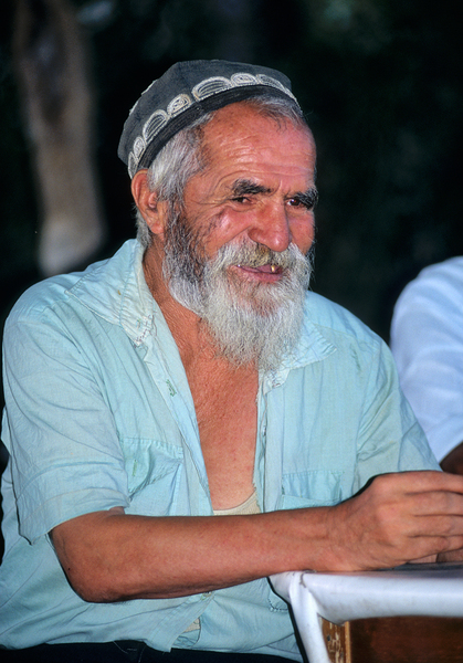 Elderly man smiles while sitting outdoors in Bukhara Uzbekistan Digital Download