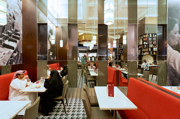 Dining in a modern restaurant with reflective walls in Dubai Digital Download