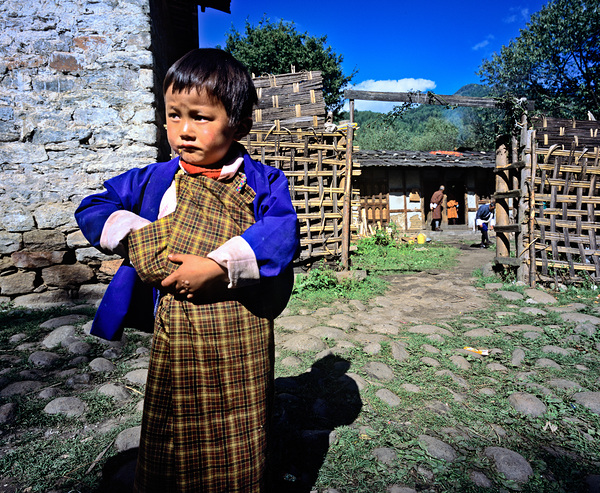 Young child in traditional Bhutanese dress in village. Digital Download