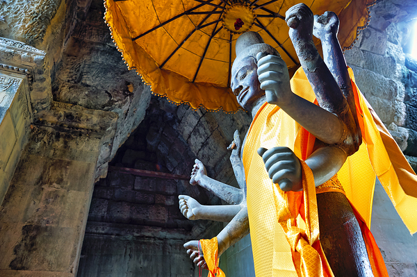 Ancient multi armed statue yellow fabric inside stone temple. Digital Download