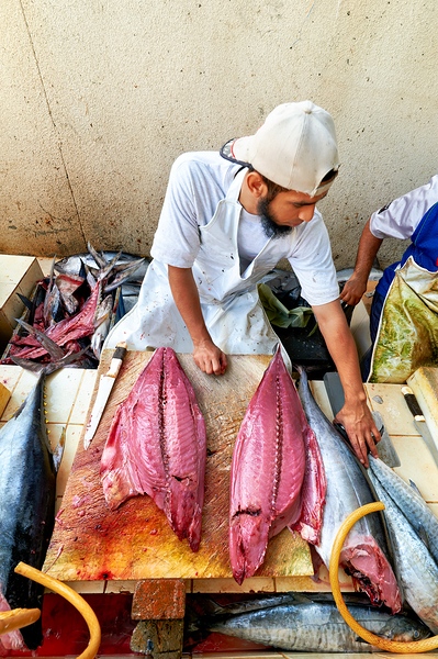 Fish market in Muscat Oman shows a vendor at work Digital Download