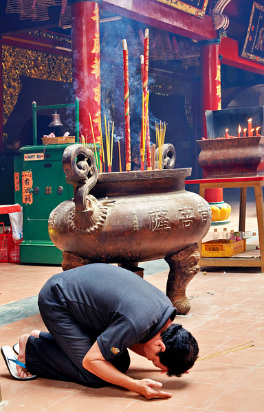 Man praying at a shrine in Ho Chi Minh City Vietnam Digital Download
