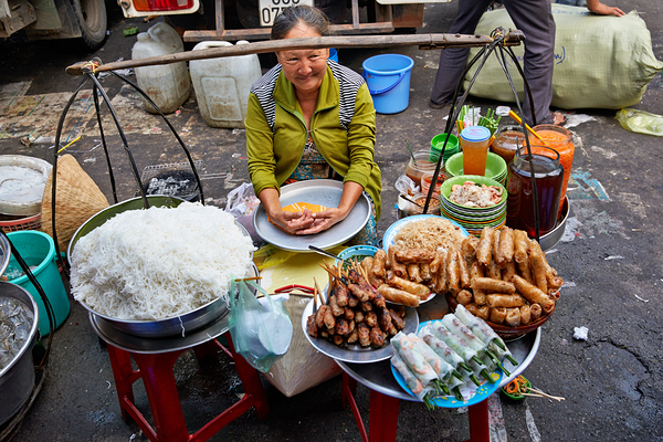 Woman selling food at street market in Ho Chi Minh City Digital Download